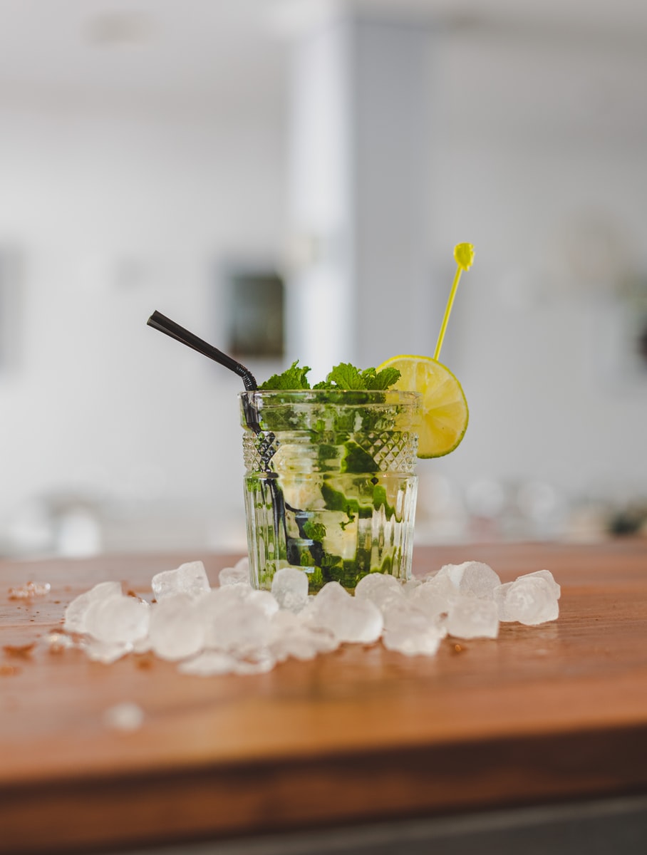 clear drinking glass with green leaf