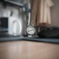 round grey alarm clock at 2:40