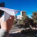 person holding paper plane