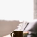 shallow focus photography of hot coffee in mug with saucer