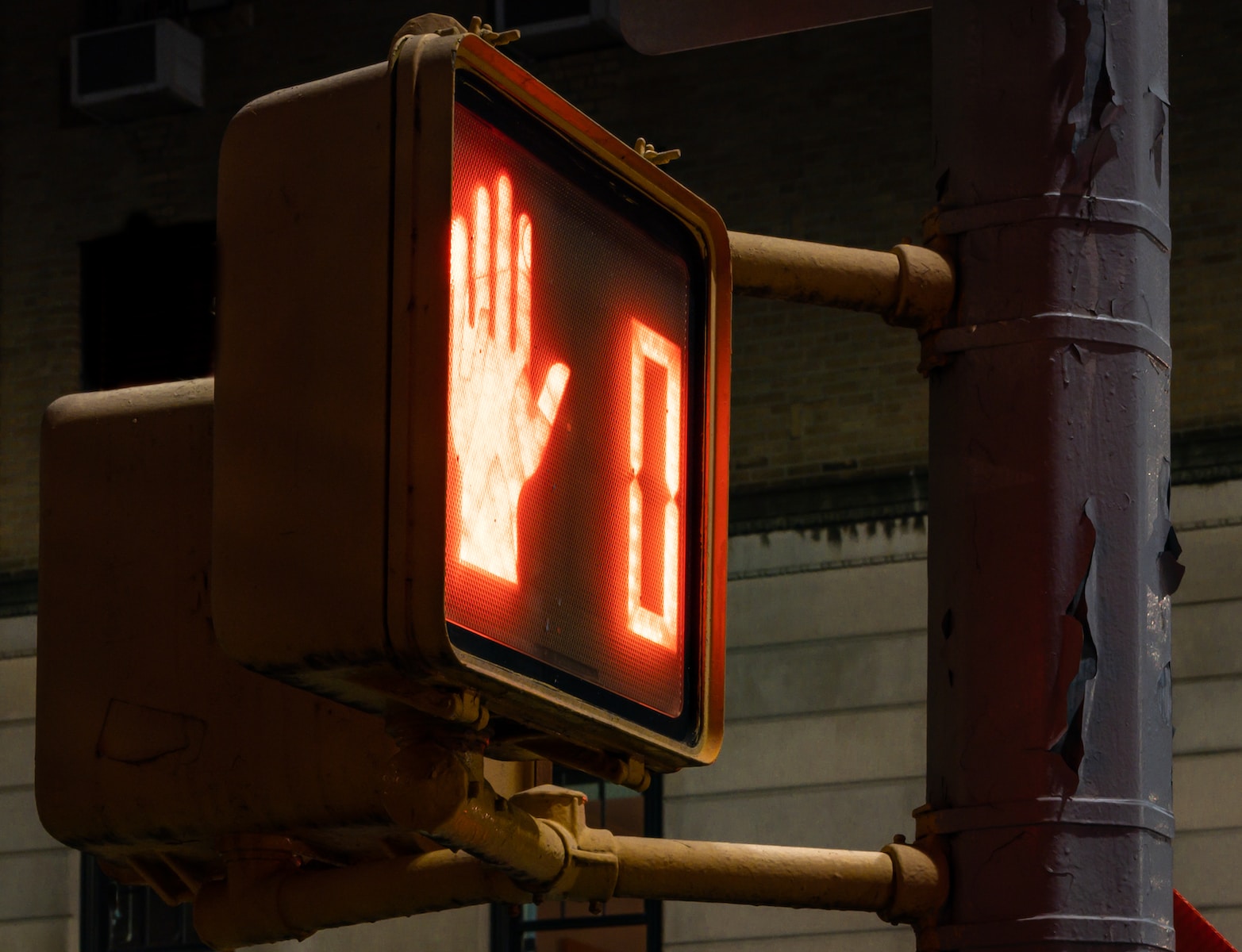 a stop light with a hand signal on it