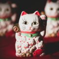 white and red ceramic cat figurine
