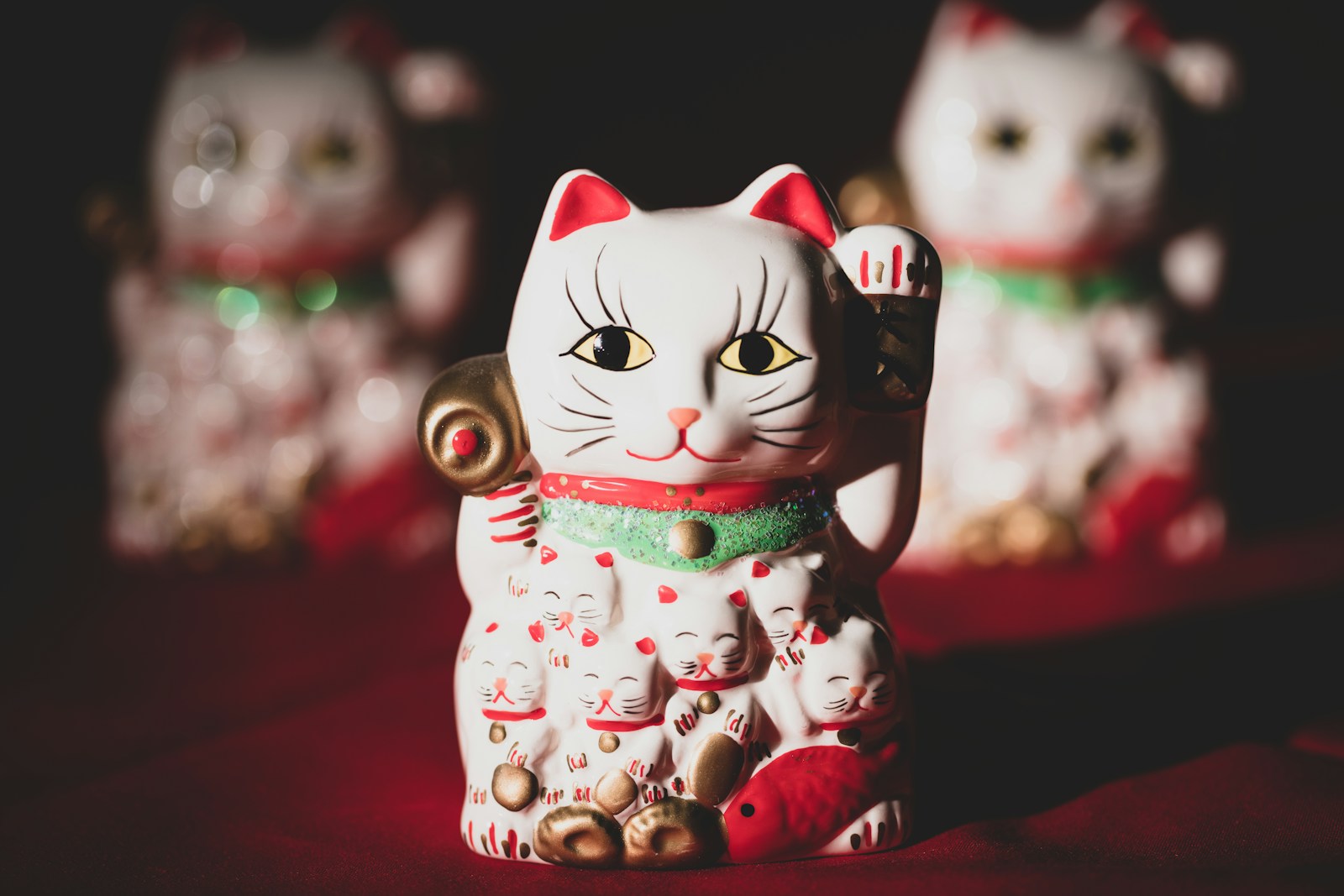 white and red ceramic cat figurine