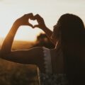 woman forming heart with her both hands