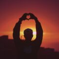 silhouette of man raising his hands