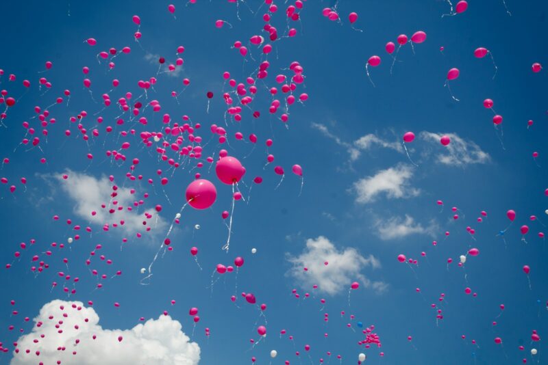 pink balloon lot on air during daytime