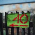 a wooden fence with a painted sign on it