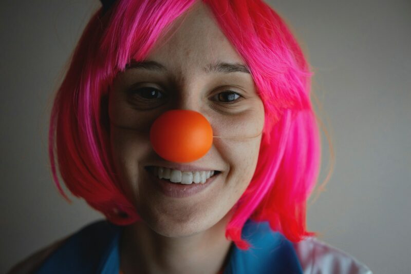 woman with pink hair wearing blue shirt