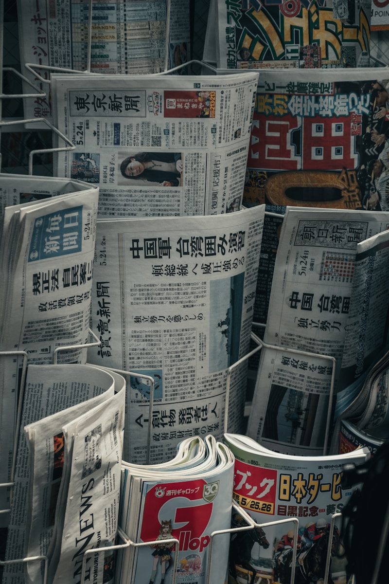 a bunch of newspapers stacked on top of each other