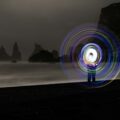a person standing on a beach with a light painting