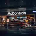A mcdonald's restaurant is illuminated at night.