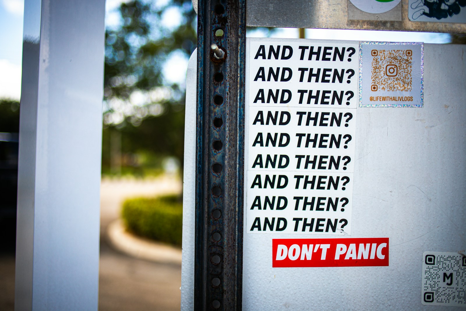 A sign on a door that says don't panic and then? and then