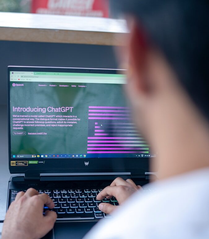 a man sitting in front of a laptop computer