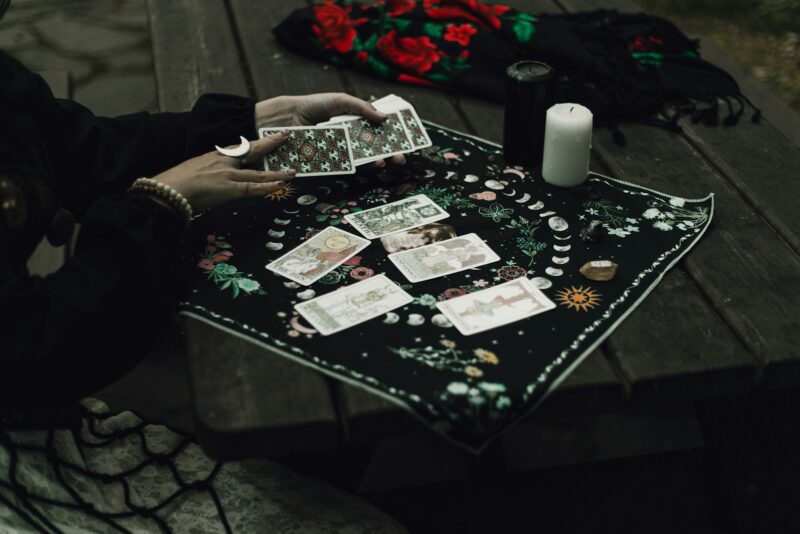 Someone is reading tarot cards outdoors.