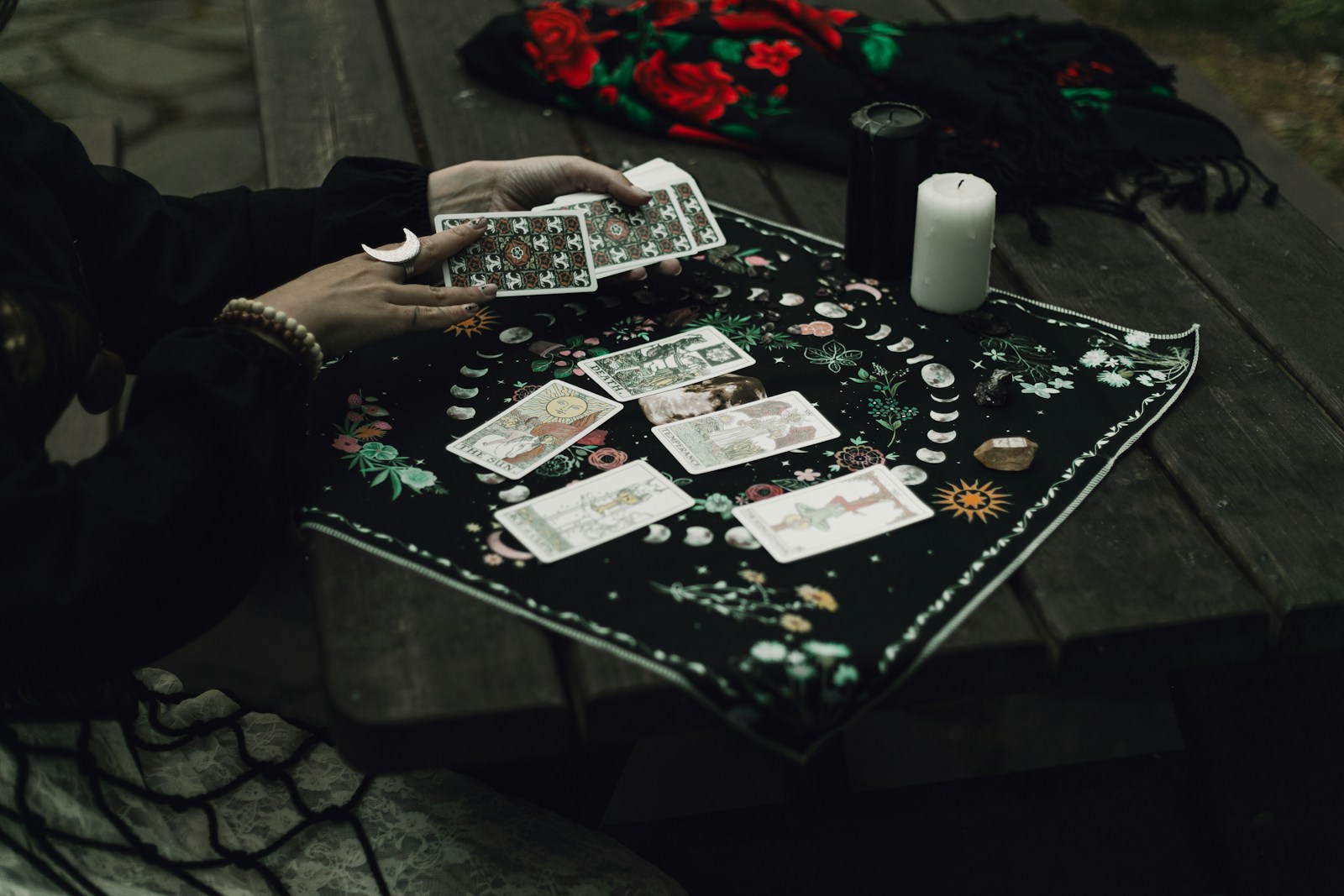 Someone is reading tarot cards outdoors.